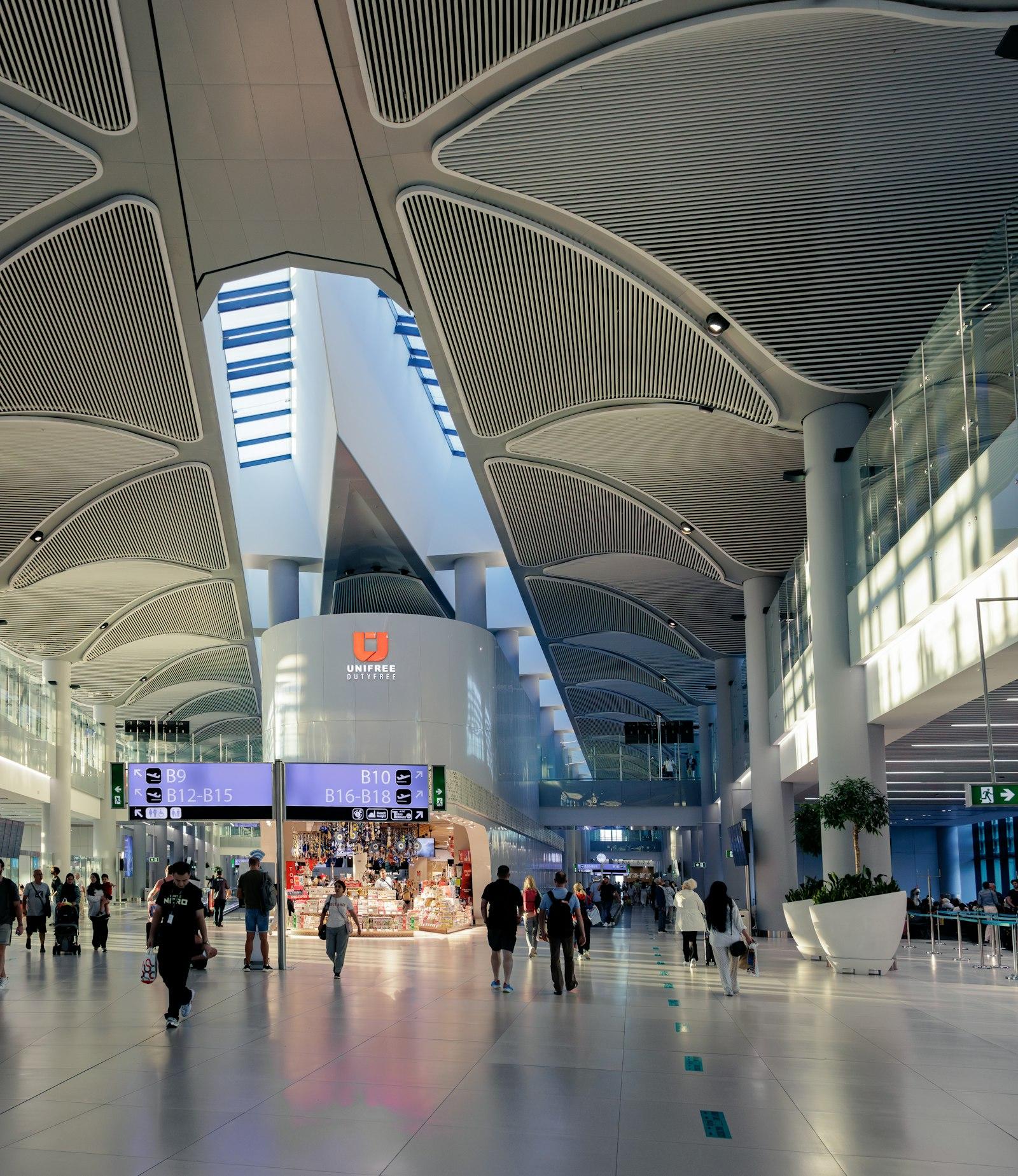 Gate signs and shops under the skylight at Istanbul Airport (IST)